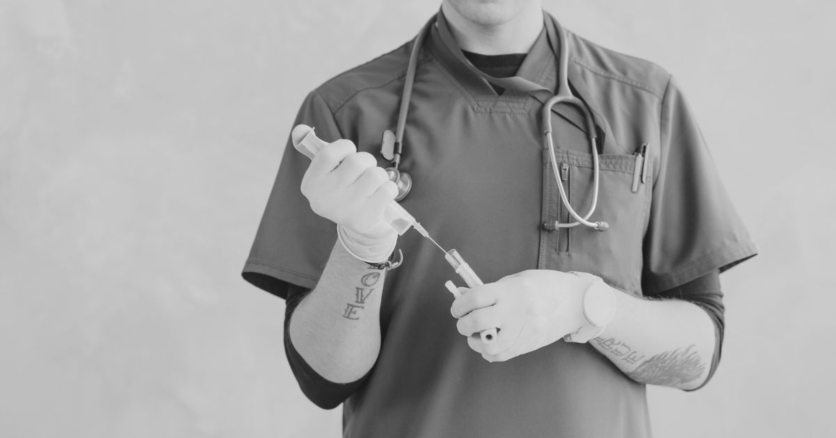 An injector holding a syringe.